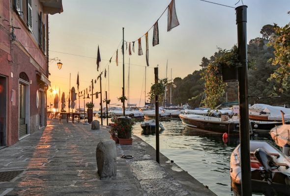 Portofino is a fishing village on the Italian Riveria coastline. It's pastel-coloured houses, luxury boutiques and seafood restaurants surround its Piazzetta, a small cobbled square overlooking the harbour, which is lined with super-yachts