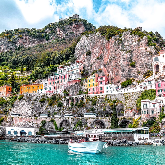 Journey by boat to Amalfi, the rocky coast’s namesake town. Formerly a maritime republic, Amalfi puts a historic spin on the seaside hubs, containing cobblestone piazzas and towering mosaicked cathedrals.