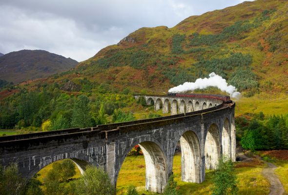 Jacobite steam train crossing the Glenfinnan viaduct in the west coast of Scotland
