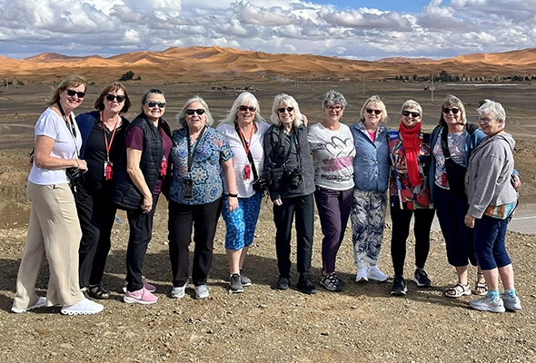 group of women with Scotland backdrop