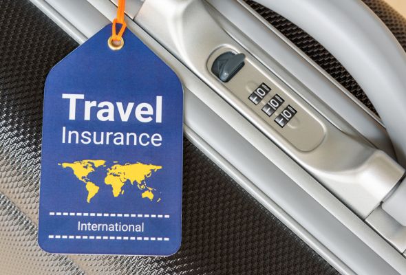 travel insurance tag attached to suitcase